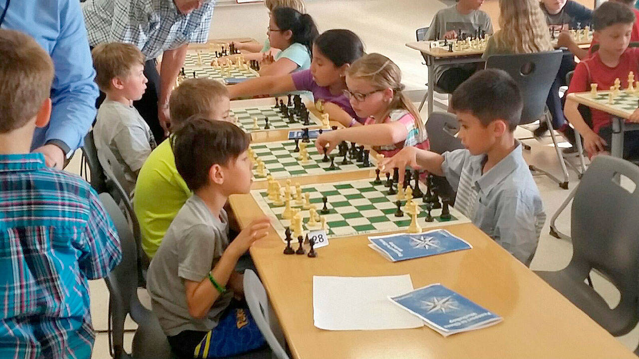 Boys and girls test their skills and strategies at a youth tournament recently staged in the Auburn High School Commons. ROBERT WHALE, Auburn Reporter