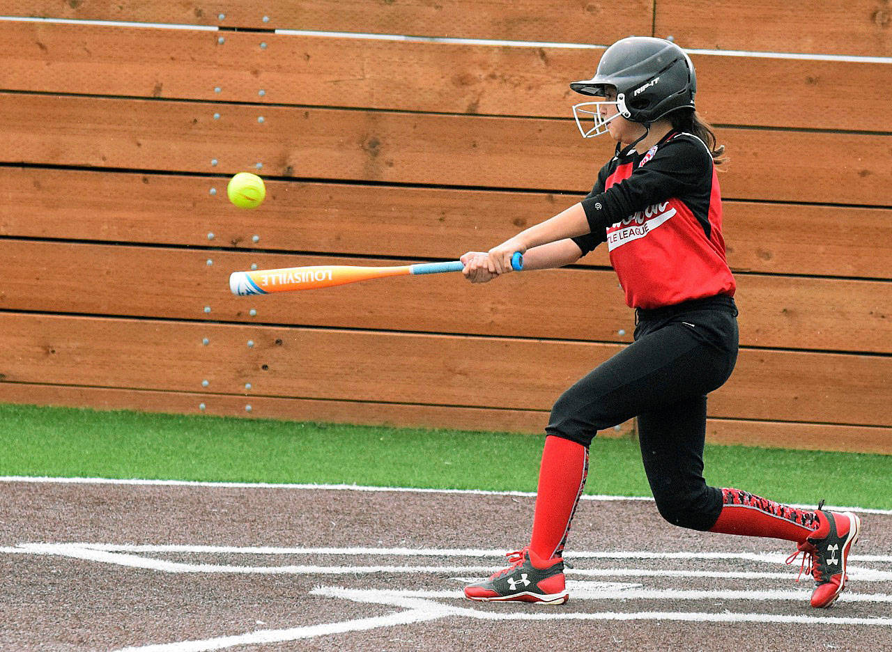 The Auburn Rainiers’ Angie Juarez connects for a hit during the championship game against the Auburn Diamond Divas. RACHEL CIAMPI, Auburn Reporter