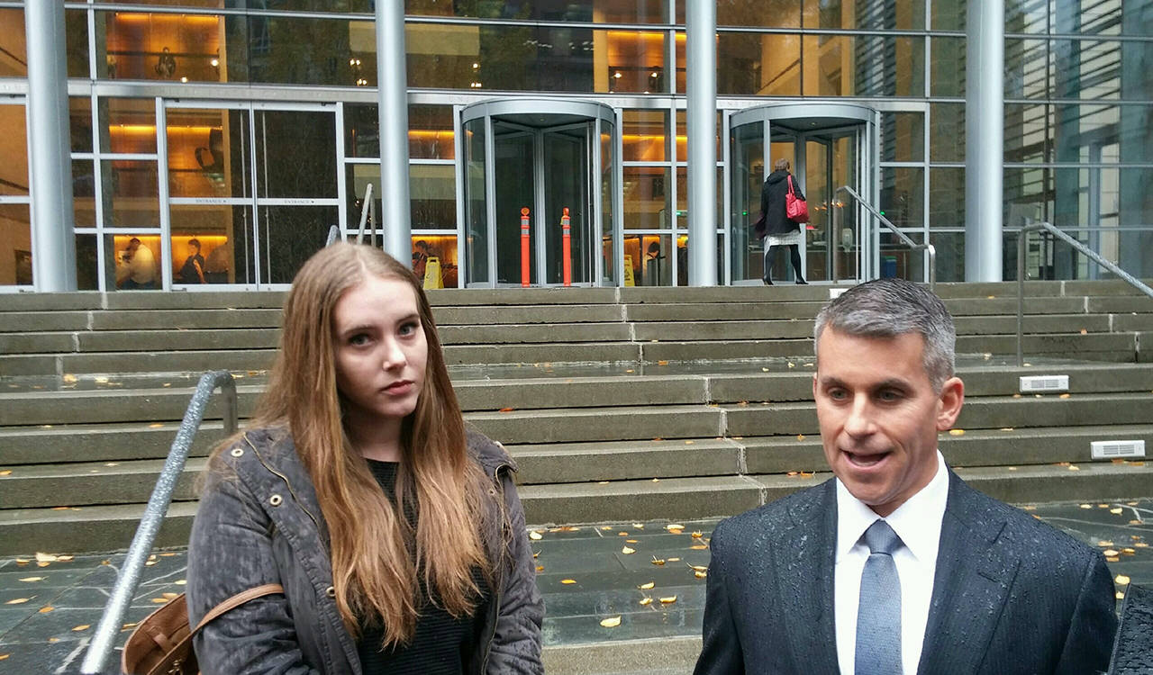 Amelia Powell (left), who has worked as a bikini barista, and Derek Newman (right), who has been representing the Everett baristas in their federal civil rights lawsuit, seen here in November 2017 in Seattle. Newman in May 2018 sought to leave the case. (Rikki King / The Herald)