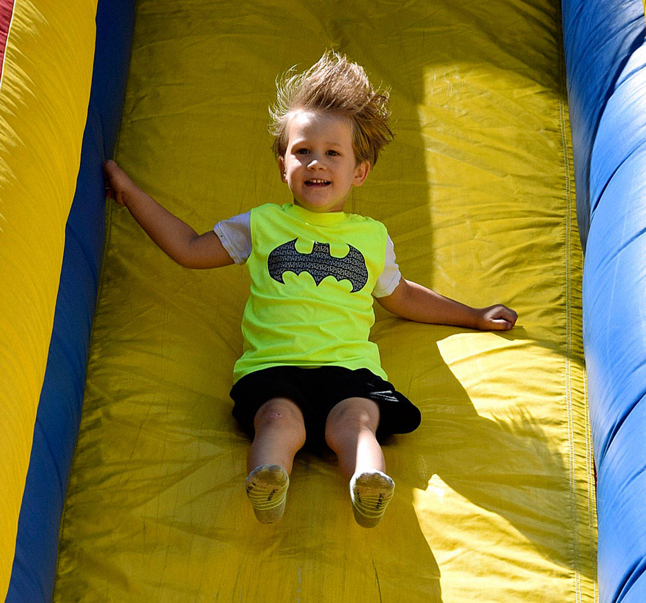 Sammy Henderson sails down an inflatable slide during Kids Day at Les Gove Park last year. RACHEL CIAMPI, Auburn Reporter