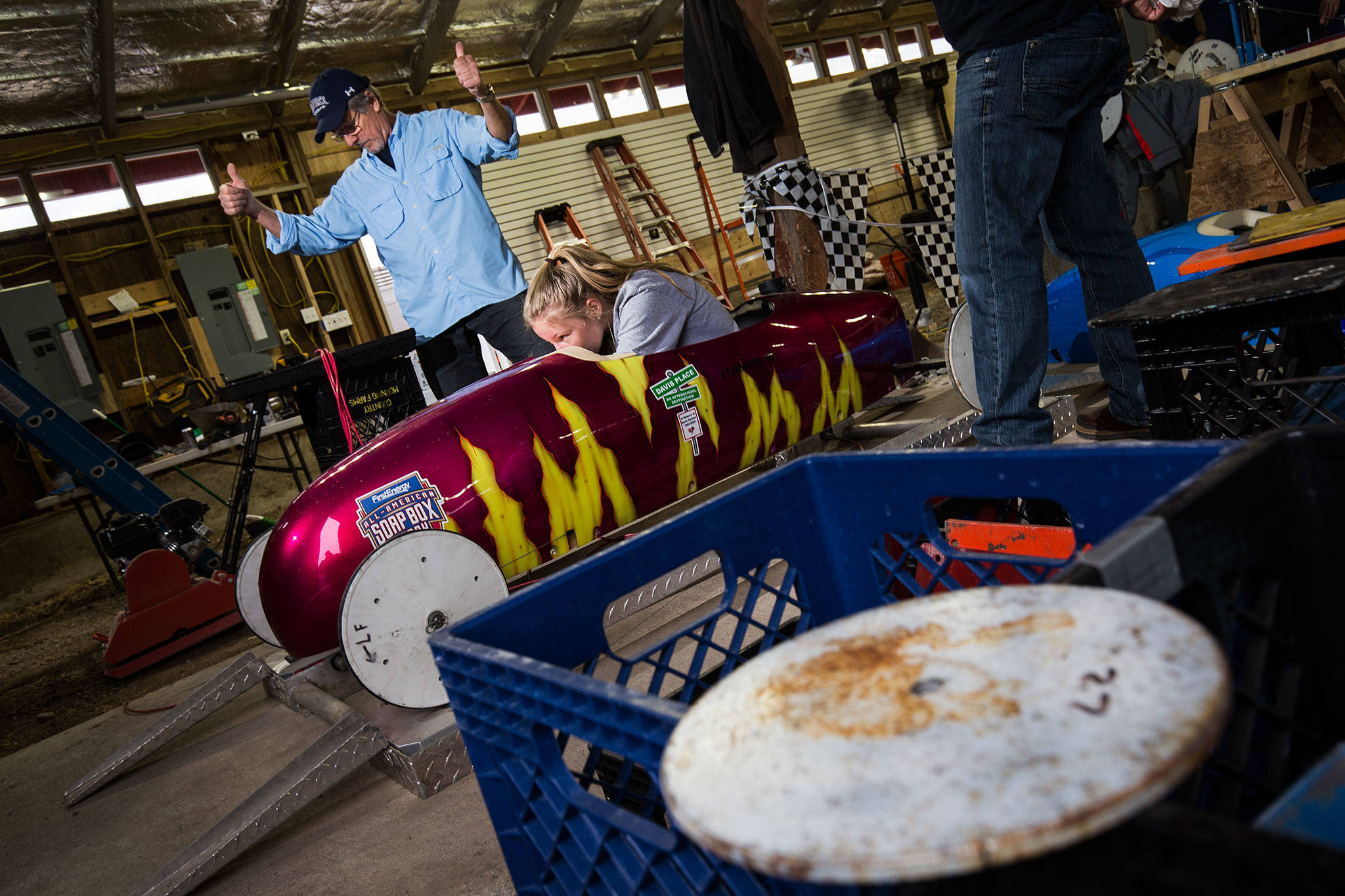 Tech team member Ron Manz gives the thumbs up as driver Tabby Holms hits the desired weight of 240 pounds in her soap box derby car during weighing at the barn June 7 on Camano Island. The 11th Stanwood-Camano Soap Box Derby takes place Saturday. (Andy Bronson / The Herald)