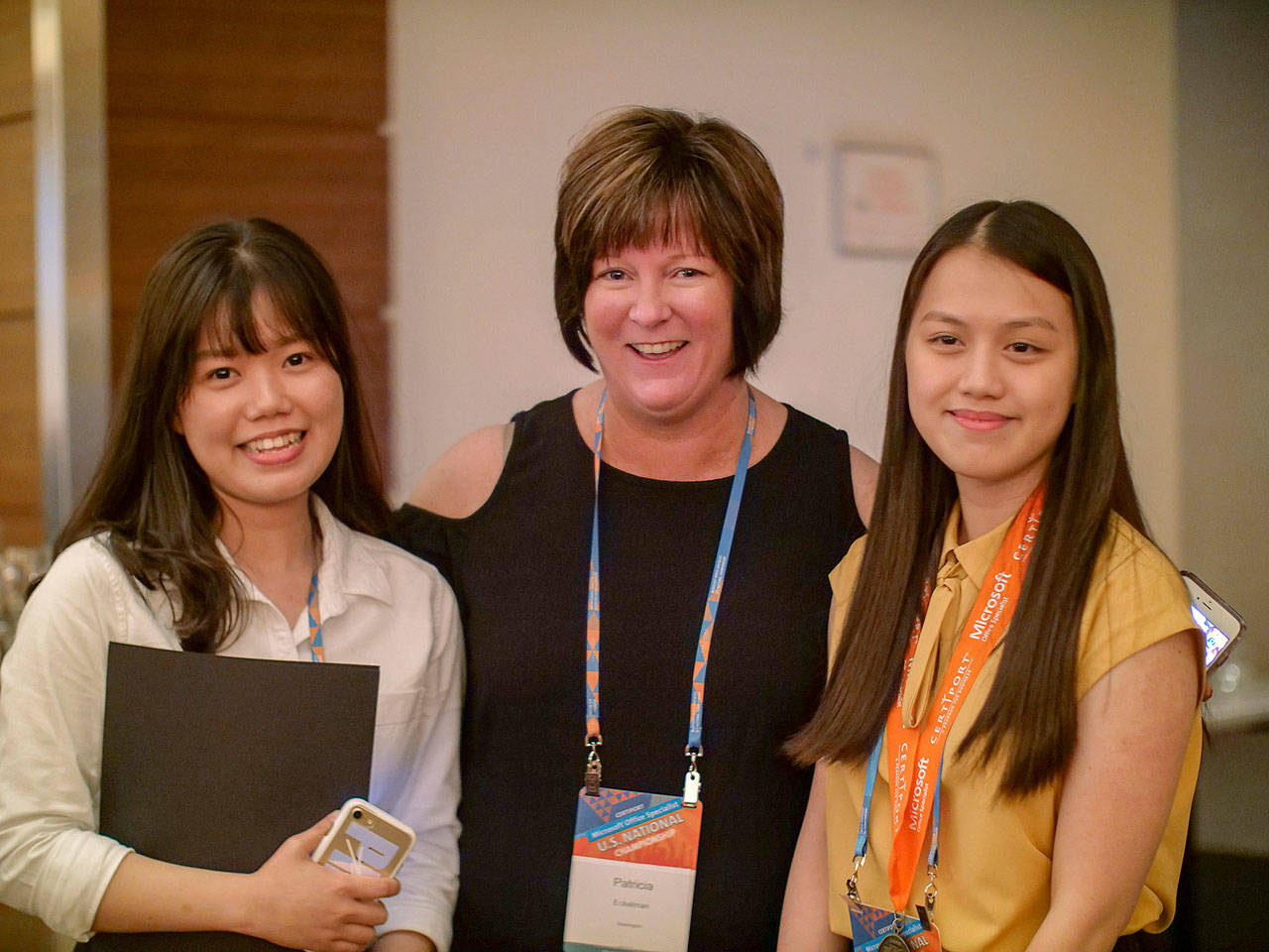 Auburn Mountainview High School graduate Linh Nguyen, far right, accepts her award, accompanied by her sister Nhi, left, who also competed in the Microsoft Office Specialist (MOS) U.S.National Championship, and their teacher, Patricia Eckelman. COURTESY PHOTO, Certiport