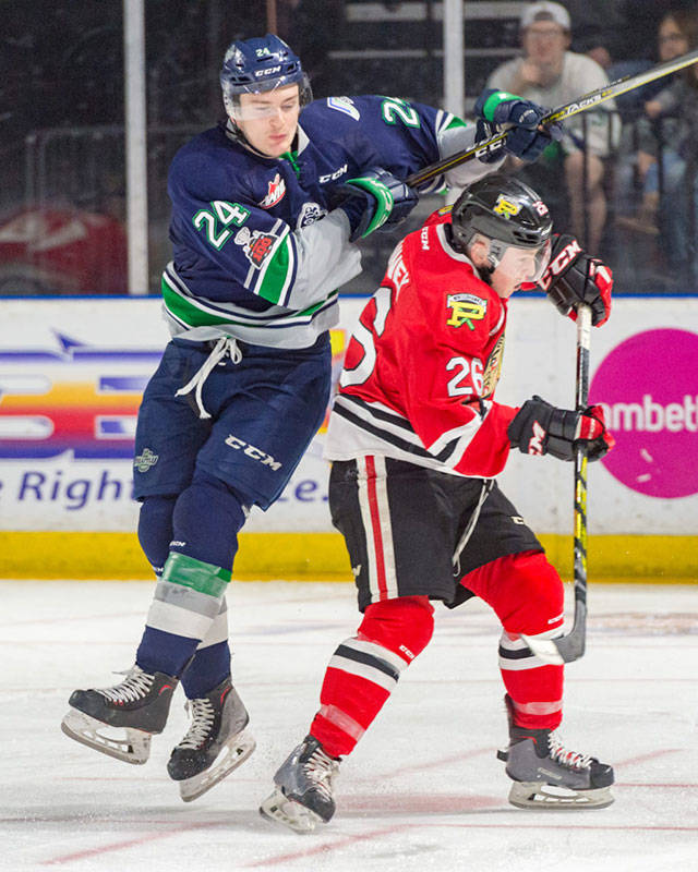 The Thunderbirds Donovan Neuls, left, collides with the Winterhawks Mason Mannek during WHL play last season. The I-5 rivals tangle again in Seattles home opener Sept. 22. COURTESY PHOTO, Brian Liesse, T-Birds