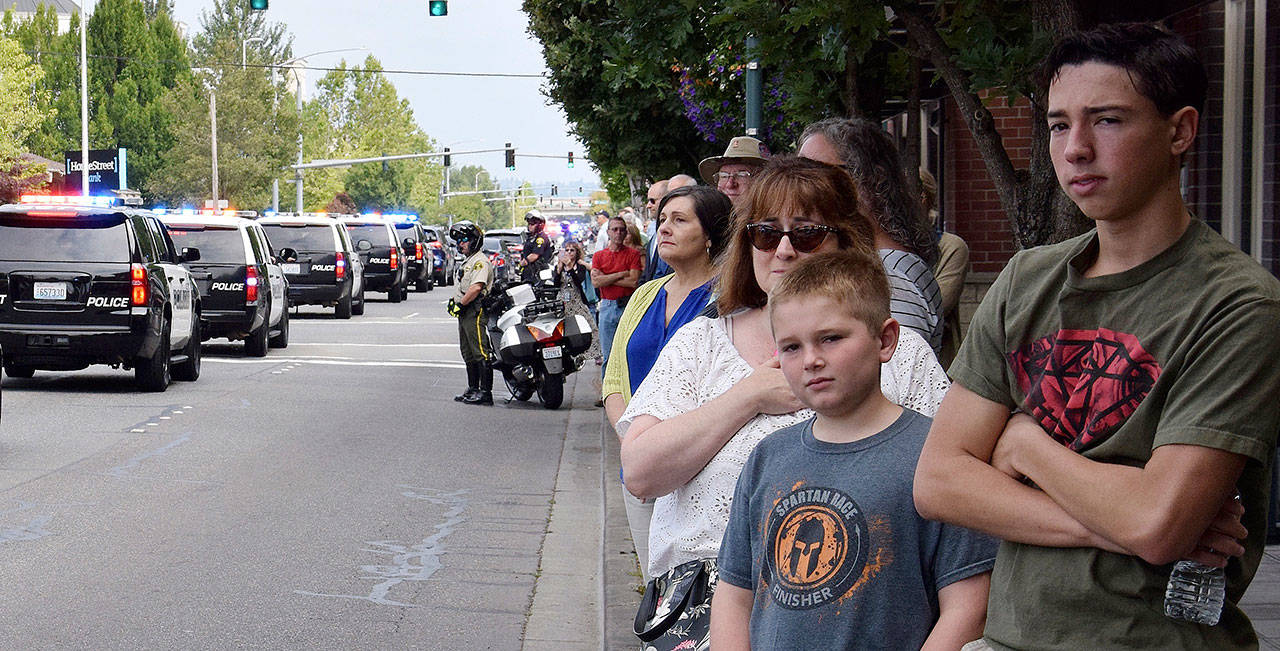 People line Fourth Avenue North as a procession for fallen Kent Police Officer Diego Moreno heads to the accesso ShoWare Center for a memorial service Tuesday. RACHEL CIAMPI, Auburn Reporter