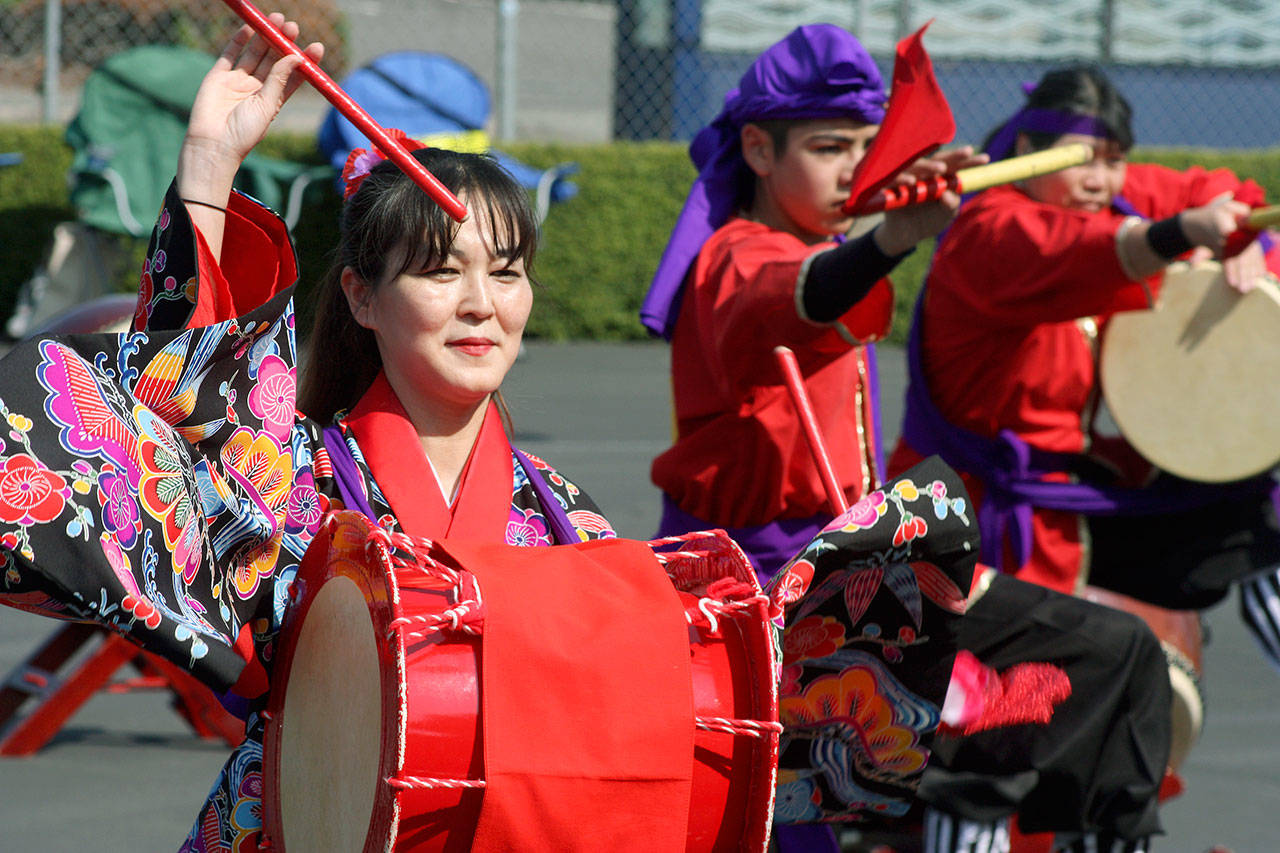 The Okinawa Kenjin-Kai Taiko group performs for the crowd during the Bon Odori Festival at the White River Buddhist Temple last Saturday. Based in Seattle, Okinawa Kenjin-Kai Taiko is a spirited group of adults and children that performs with big and hand-held taiko drums and other instruments. MARK KLAAS, Auburn Reporter