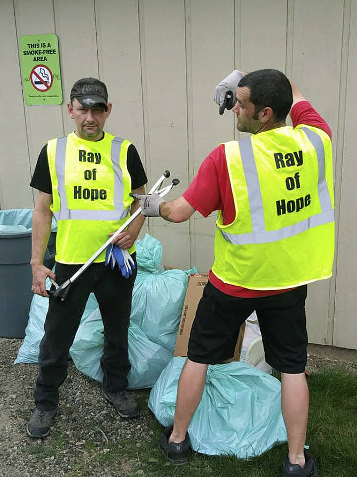 Two homeless men who benefit from services available at the Ray of Hope day shelter volunteer their cleanup skills for the benefit of the Auburn community. COURTESY PHOTO