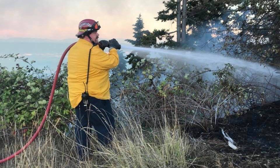 The VRFA applies water to a burnt, dry hillside in efforts to mop up a nasty brush fire that threatened homes Saturday. COURTESY PHOTO, VRFA