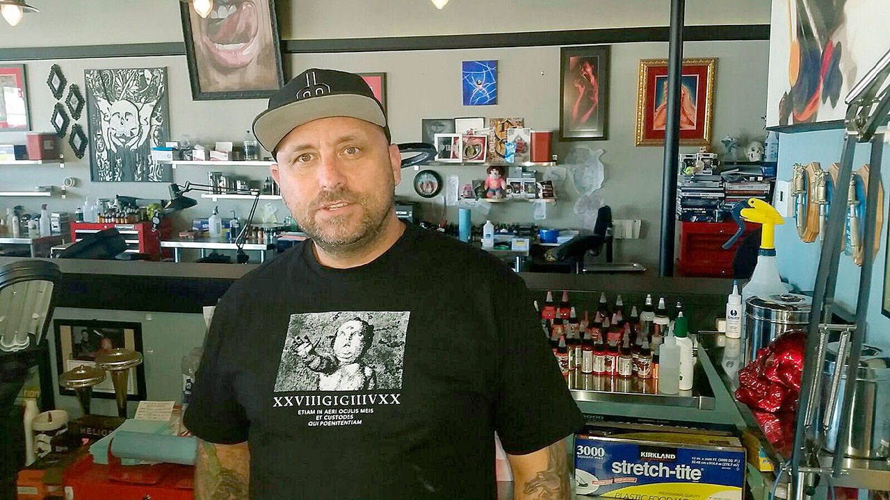 Action Tattoo owner Rich White, amid the implements of his art. White is a reputable artist, whose work has been praised by his large clientele. ROBERT WHALE, Auburn Reporter