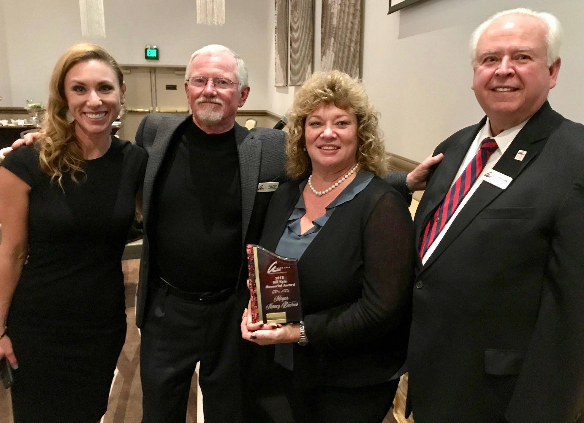 Special honor: Auburn Mayor Nancy Backus, third from left, receives the Bill Kyle Service Award at the Auburn Area Chamber of Commerce’s Spotlight Awards show at the Muckleshoot Casino on Wednesday. Joining Backus at the presentation are, from left, Kacie Bray, president and CEO of the chamber; Doug Happe, chairman of the board at the chamber; and Pete Lewis, former mayor. MARK KLAAS, Auburn Reporter