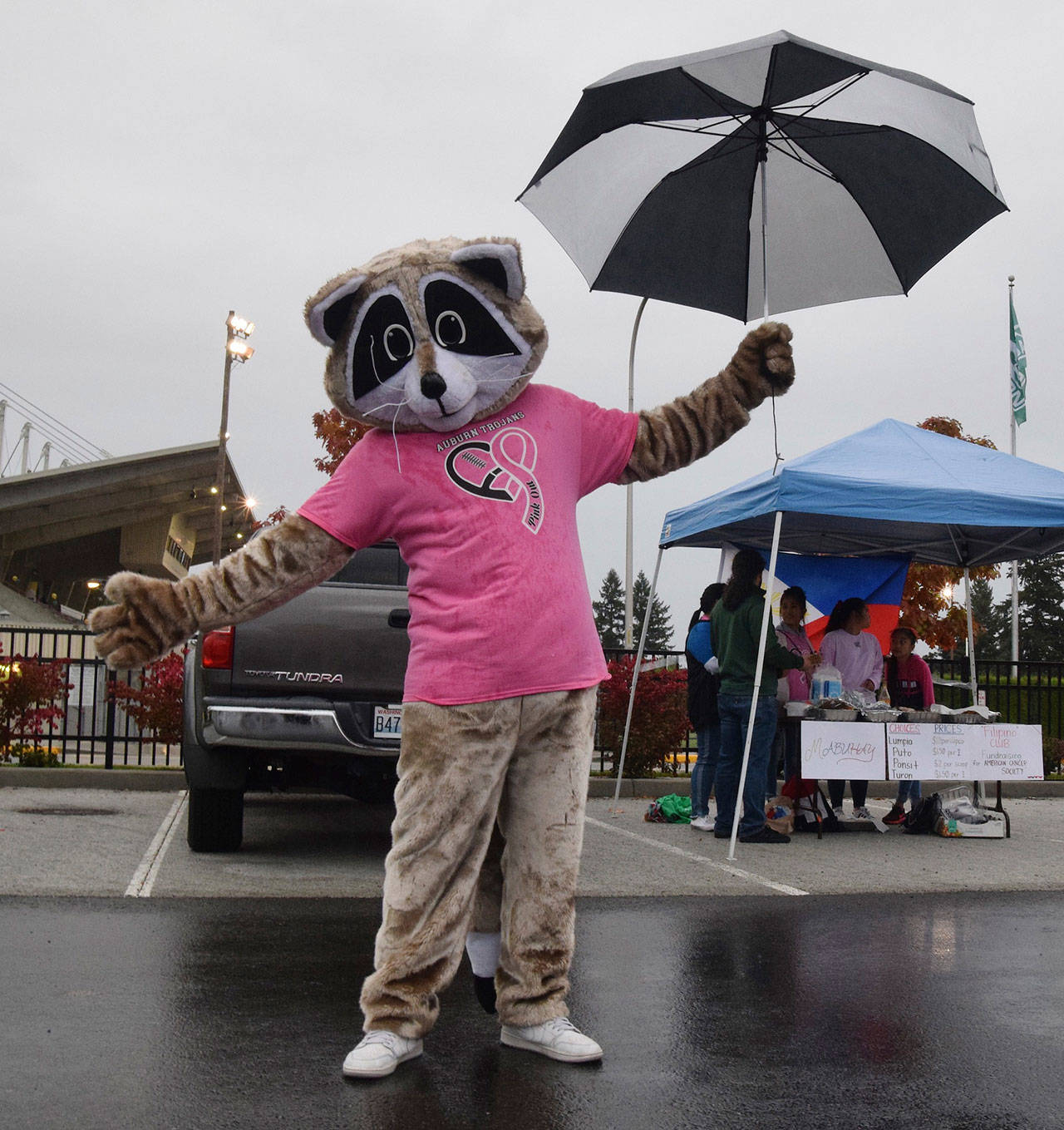 Auburn Highs pink-clad event mascot, Squirrel, welcomes guests to the tailgate party Friday. RACHEL CIAMPI, Auburn Reporter