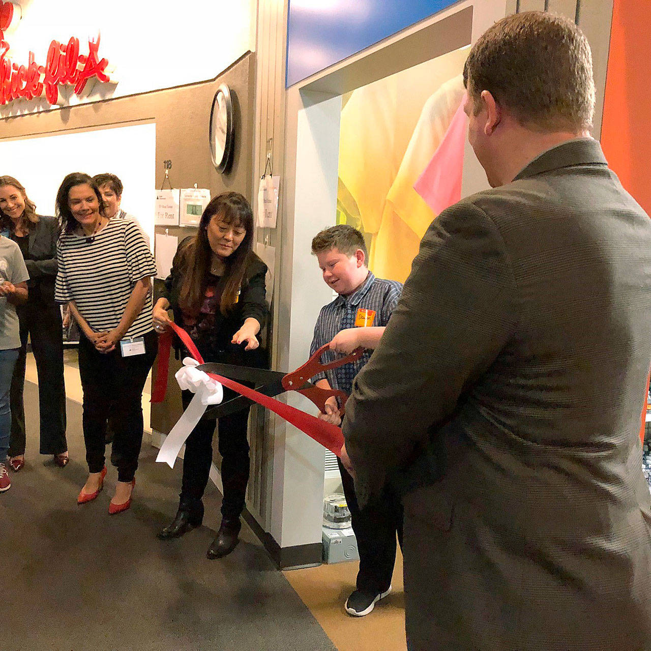 Students join JA, civic leaders and Walmart representatives in the opening and ribbon cutting of two new educational storefronts at Auburn’s JA World on Oct. 5. COURTESY PHOTO