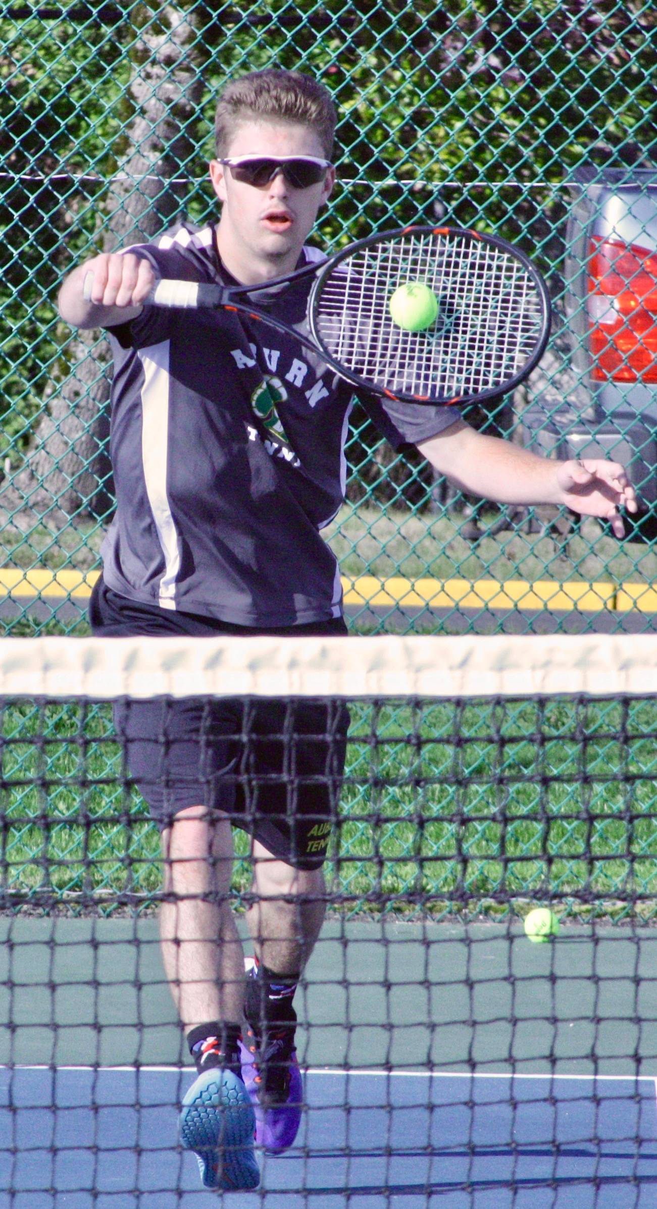 Auburn’s Rhett Stein returns a shot during his three-set victory against Enumclaw’s Eric Thompson on Wednesday. Set scores were 3-6, 6-1, 11-9. KEVIN HANSON, The Courier-Herald