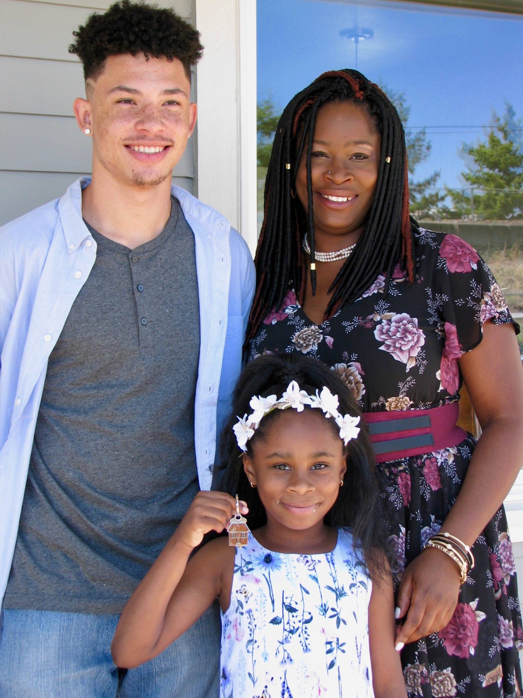 Tenee Baker, with son Jadon and daughter Saniyah, in front of their new home in Pacific. COURTESY PHOTO, Habitat for Humanity