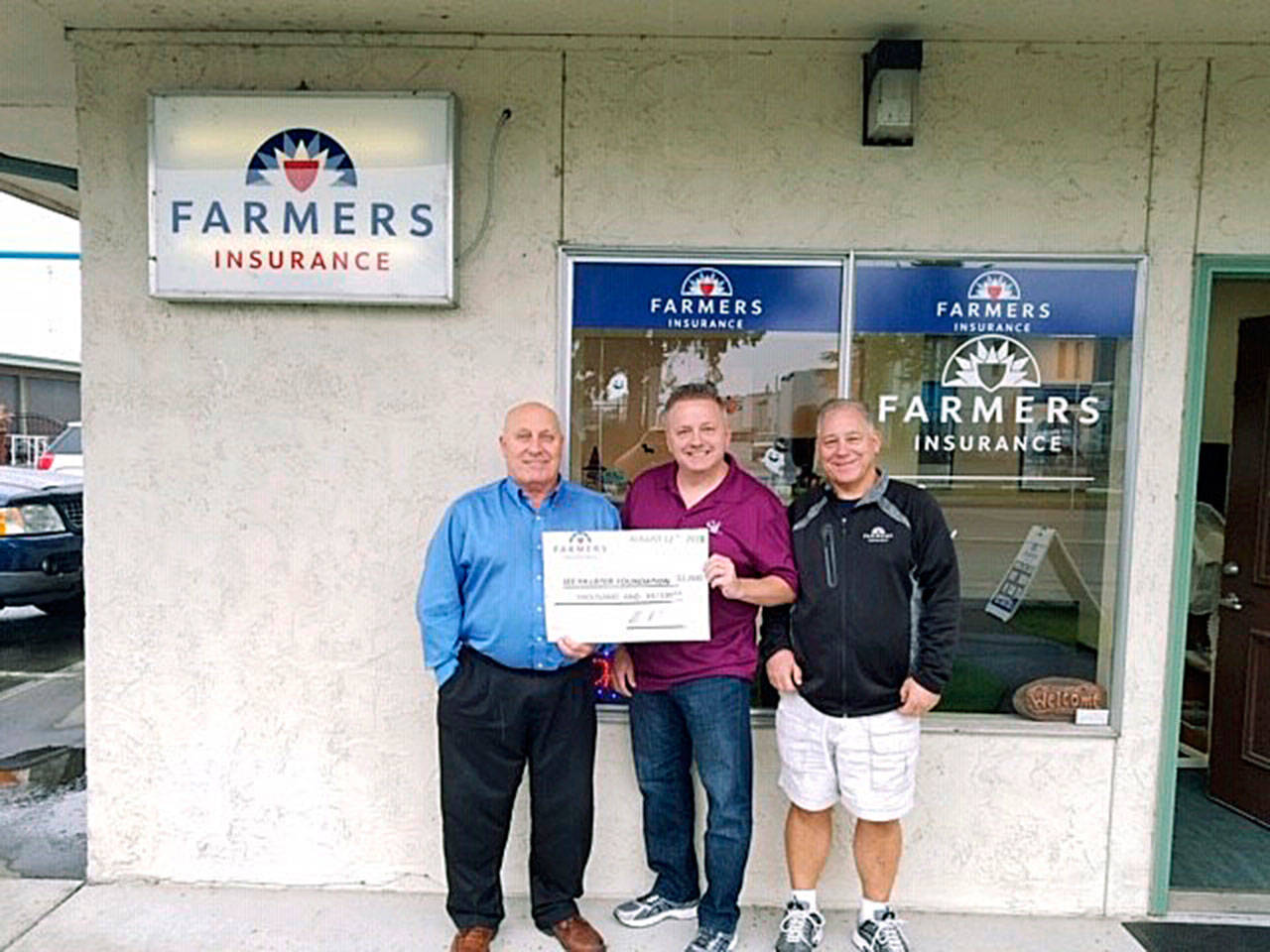 Farmers Insurance presents a check to the See Ya Later Foundation. Brian Williams of the foundation, middle, receives the check from the Auburn Farmers branchs Russ Kemp, left, and Brian Berend. COURTESY PHOTO