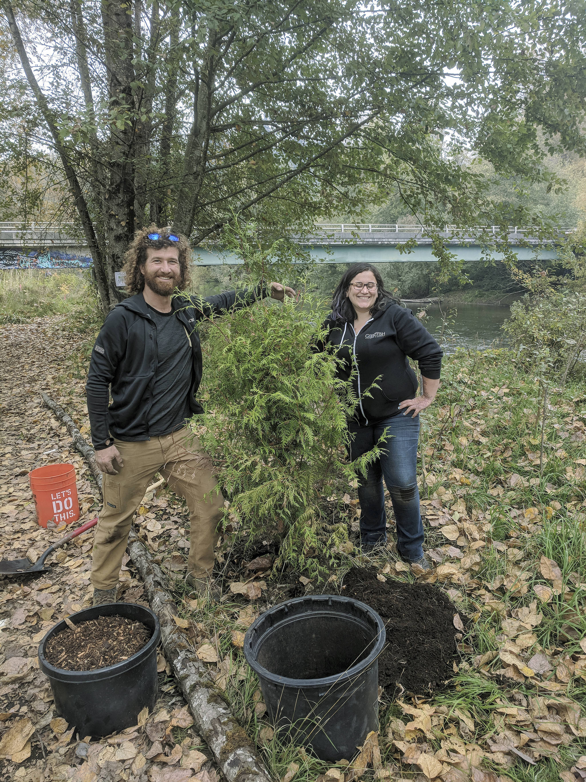 Peter Elkins and Tina Hope, student interns from Green River College who work with the Green River Coalition, plant new vegetation along the banks of the Green River last Saturday. COURTESY PHOTO