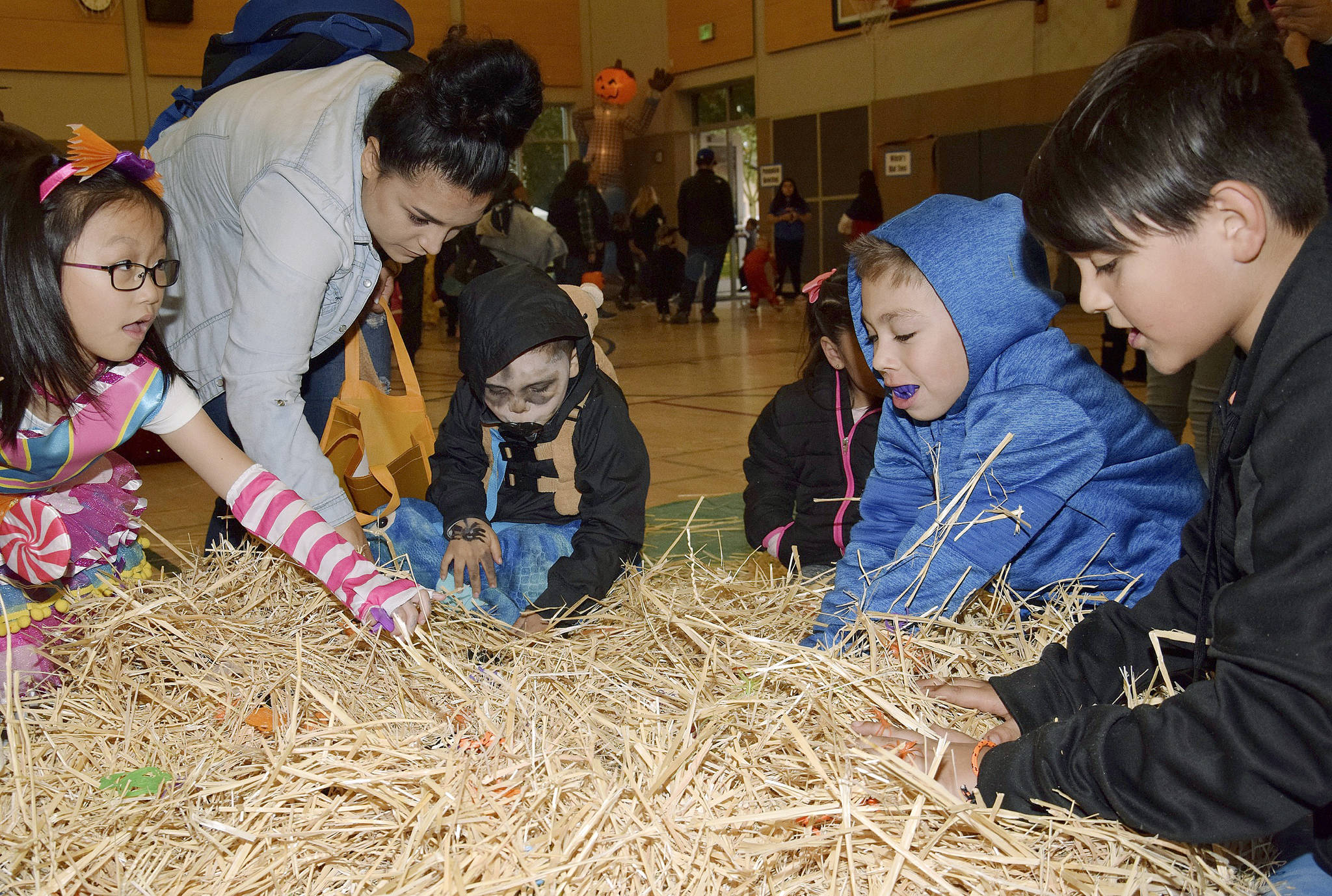 Kids hunt for sweets in the Candy In The Hay game. RACHEL CIAMPI, Auburn Reporter