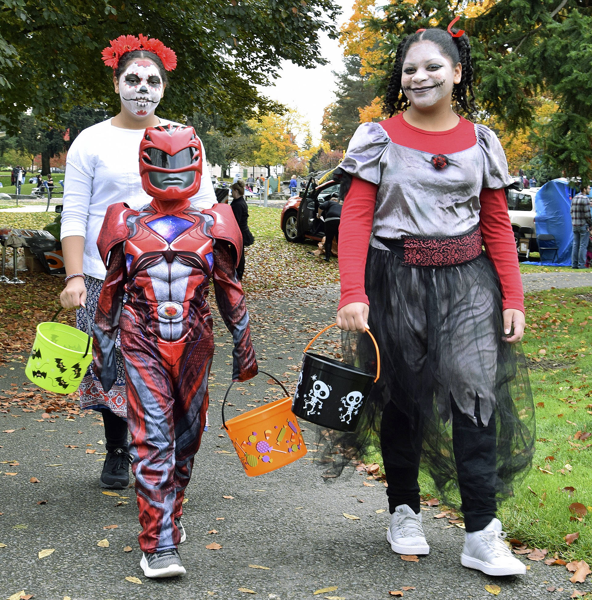 Marie, Brianna and Raymond Fugate get ready for trick-or-treating at Les Gove Park.