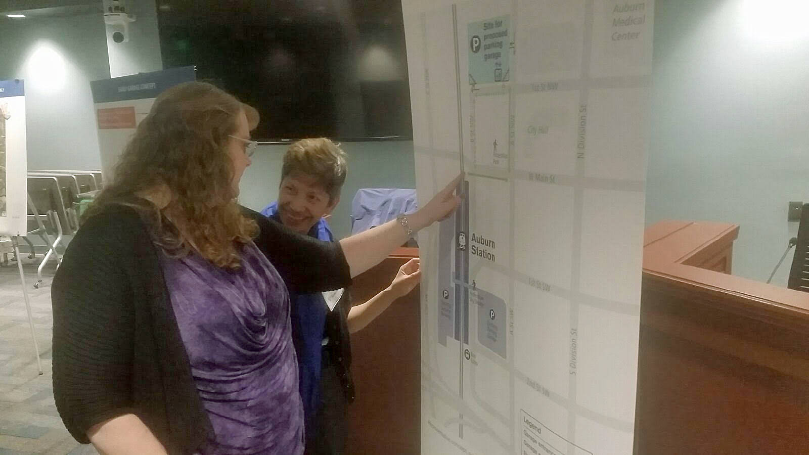 Sound Transit organized an open house Tuesday night to discuss its second garage in Auburn. Inspecting displays here are, foreground, Ingrid Gaub, public works director for the City of Auburn, and Elma Borbe, an environmental planner for Sound Transit. ROBERT WHALE, Auburn Reporter