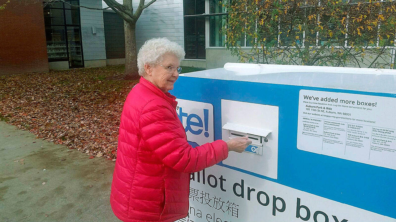 Myrna Ostrom deposits her ballot at the Auburn Library on Tuesday, election day. ROBERT WHALE, Auburn Reporter