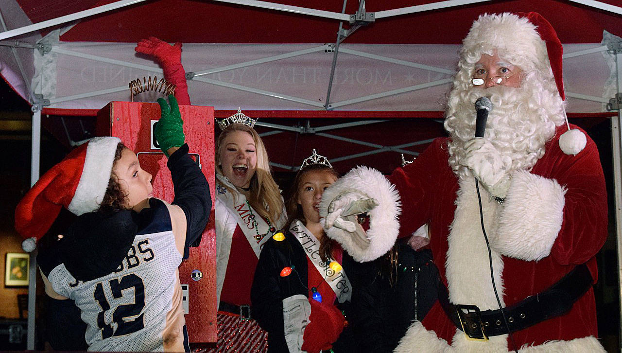 Santa Claus has James Jacobs flip the switch to light up the Christmas tree in City Hall Plaza last year. An Auburn tradition, the lighting followed a holiday parade down Main Street. RACHEL CIAMPI, Auburn Reporter