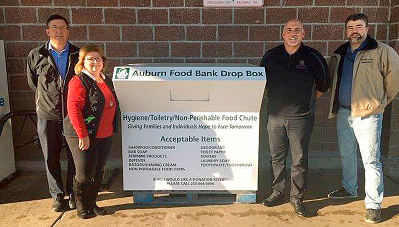 Auburn Safeway Manager Tim May, left, Auburn Food Bank Director Debbie Christian, Spectrum Signs owner Mike Harbin and Matt deKerrie of Ferrell Gas officially welcome back into service the Auburn Food Banks’s hygiene and nonperishable food donation box, this time at the Safeway at 101 Auburn Way S., during a Dec. 5 gathering. COURTESY PHOTO, Auburn Food Bank