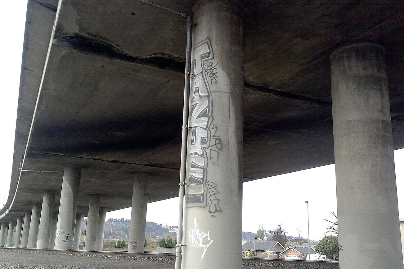 Graffiti decorates the foundation of the State Route 18 overpass in Auburn. City officials are looking at ways to confront a chronic problem. FILE PHOTO