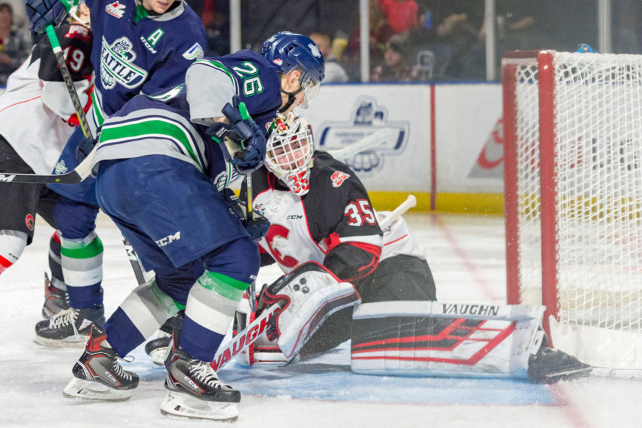 The Thunderbirds’ Nolan Volcan works to push the puck past Prince George goalie Taylor Gauthier during WHL play Tuesday night. COURTESY PHOTO, Brian Liesse, T-Birds