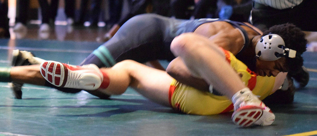 Auburn Riverside’s Yusef Nelson tangles with Orting’s Conor Goucher, prevailing in overtime 12-10 for the 126-pound championship of the Doc Herren Invitational at Bob Jones Gymnasium last Saturday. RACHEL CIAMPI, Auburn Reporter