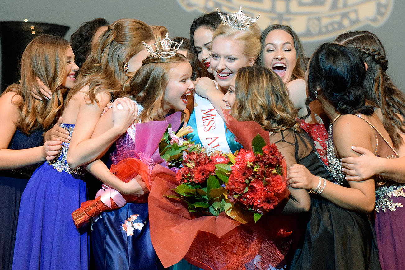 Contestants swarm Whitney Van Vleet, wearing the coveted crown, right, after she won the Miss Auburn title at the Performing Arts Center last year. Olivia Thomas, with the tiara, left, earlier took Miss Auburn’s Outstanding Teen title. RACHEL CIAMPI, Auburn Reporter