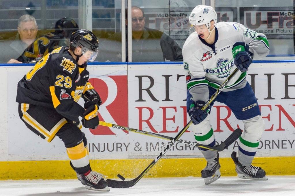 The Thunderbirds Samuel Huo, right, advances the puck against the Wheat Kings. COURTESY PHOTO, Brian Liesse, T-Birds