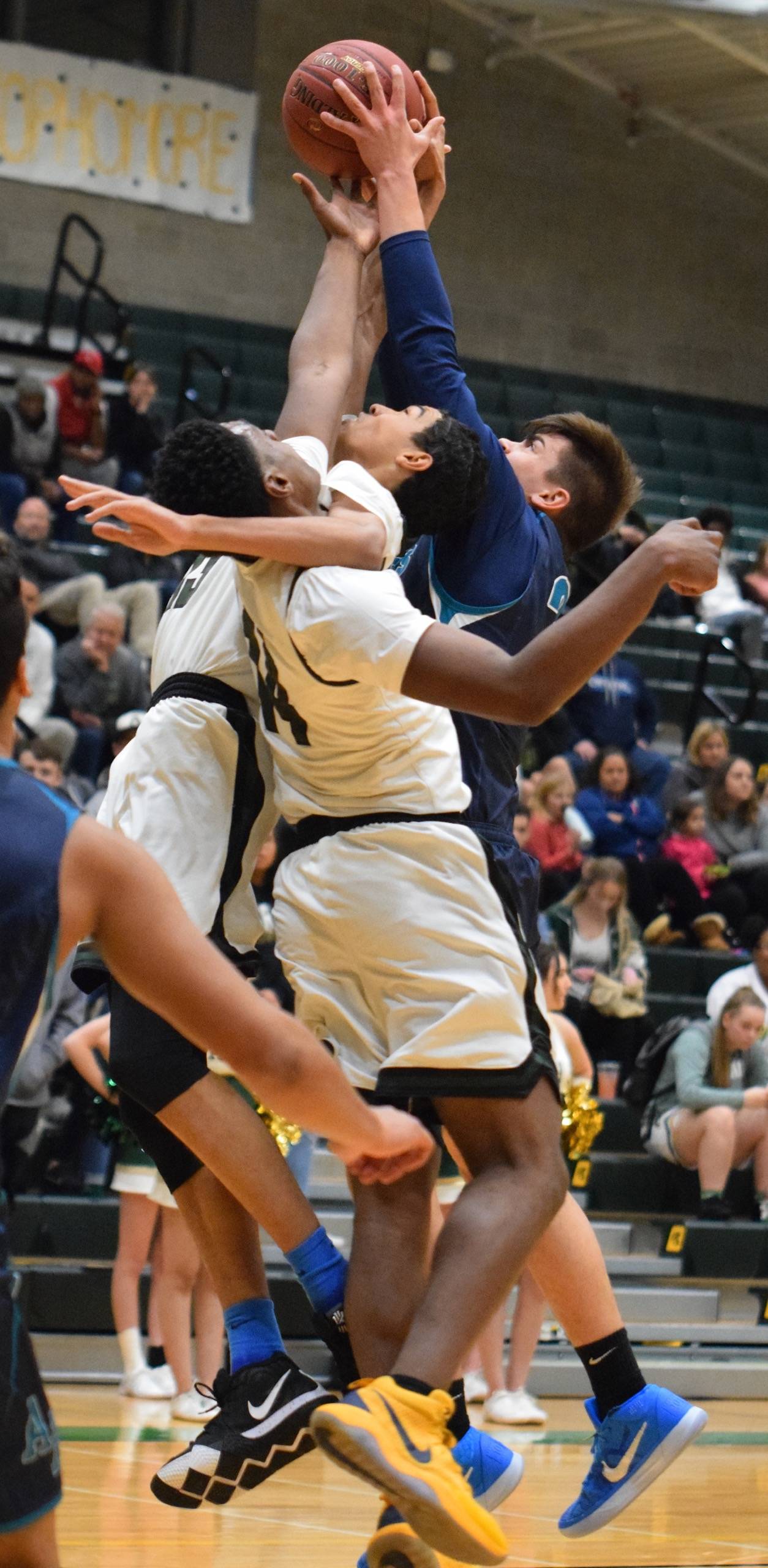 Auburn Riverside’s Cole Lenihan (33) battles Auburn’s Isaiah Dunn (14) and Darrell Hester (13) for the rebound during NPSL Olympic action last Friday night. RACHEL CIAMPI, Auburn Reporter