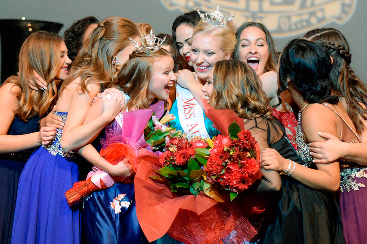 Contestants swarm Whitney Van Vleet, wearing the coveted crown, right, after she won the Miss Auburn title at the Performing Arts Center last year. Olivia Thomas, with the tiara, left, earlier took Miss Auburn’s Outstanding Teen title. RACHEL CIAMPI, Auburn Reporter