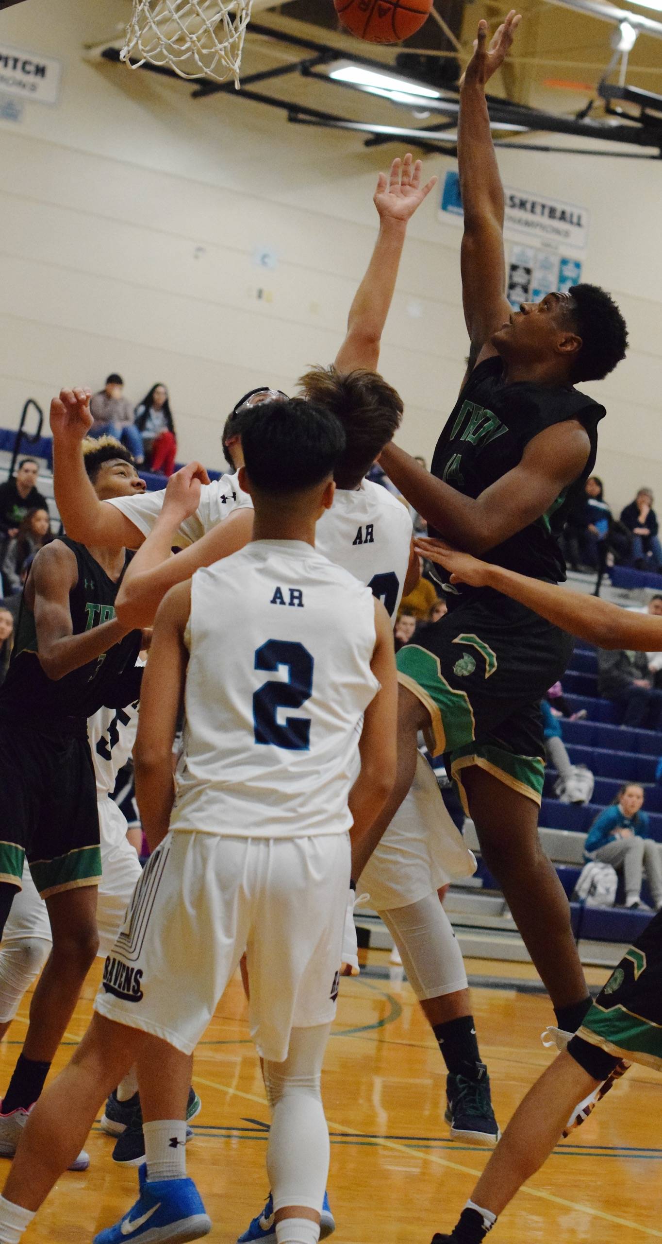 Auburn’s Isaiah Dunn drives inside to shoot over the Auburn Riverside zone during NPSL Olympic play Friday night. RACHEL CIAMPI, Auburn Reporter