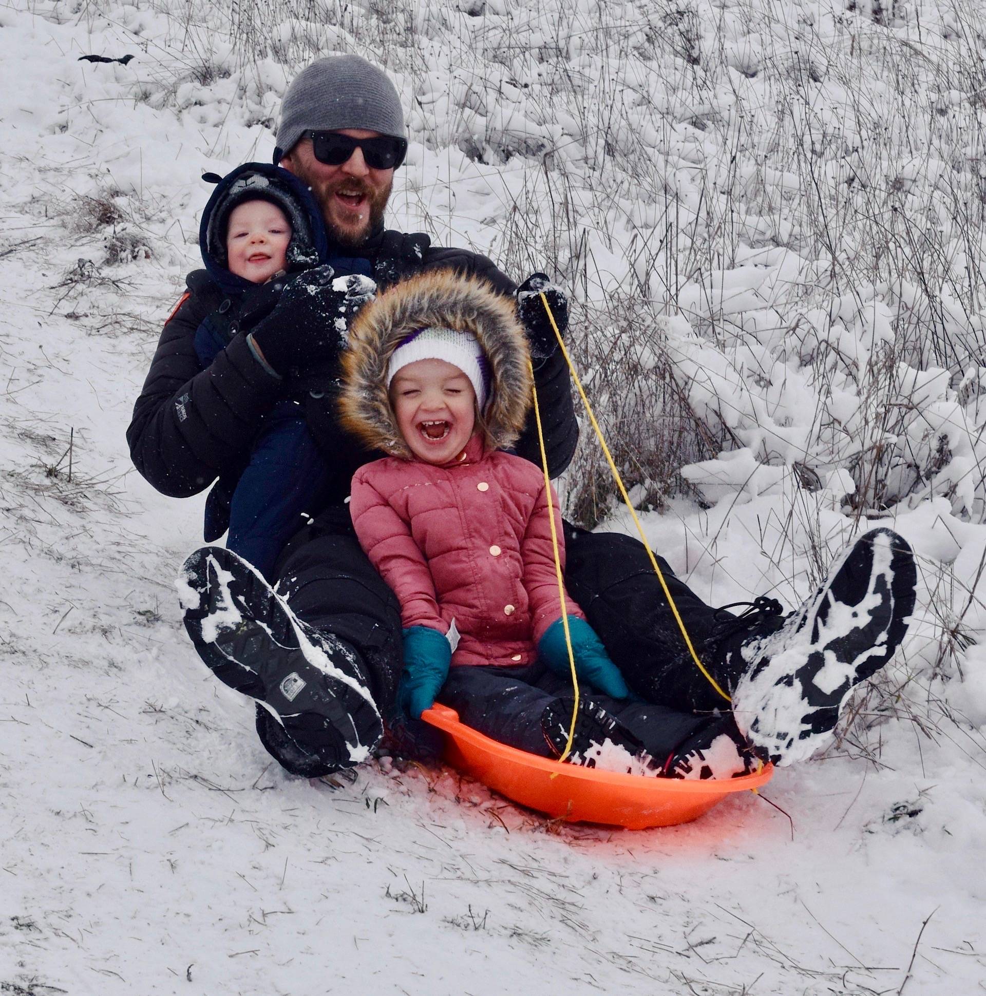 Steve Martin slides down a snow-caked hill in Auburn, with his kids Aevri, 3, and Eathan, 7 months, on Monday. A winter storm blasted Auburn and the greater valley overnight, closing schools, roads and canceling activities. The freeze canceled classes and impacted those working Monday and Tuesday. Schools reopened Wednesday. RACHEL CIAMPI, Auburn Reporter