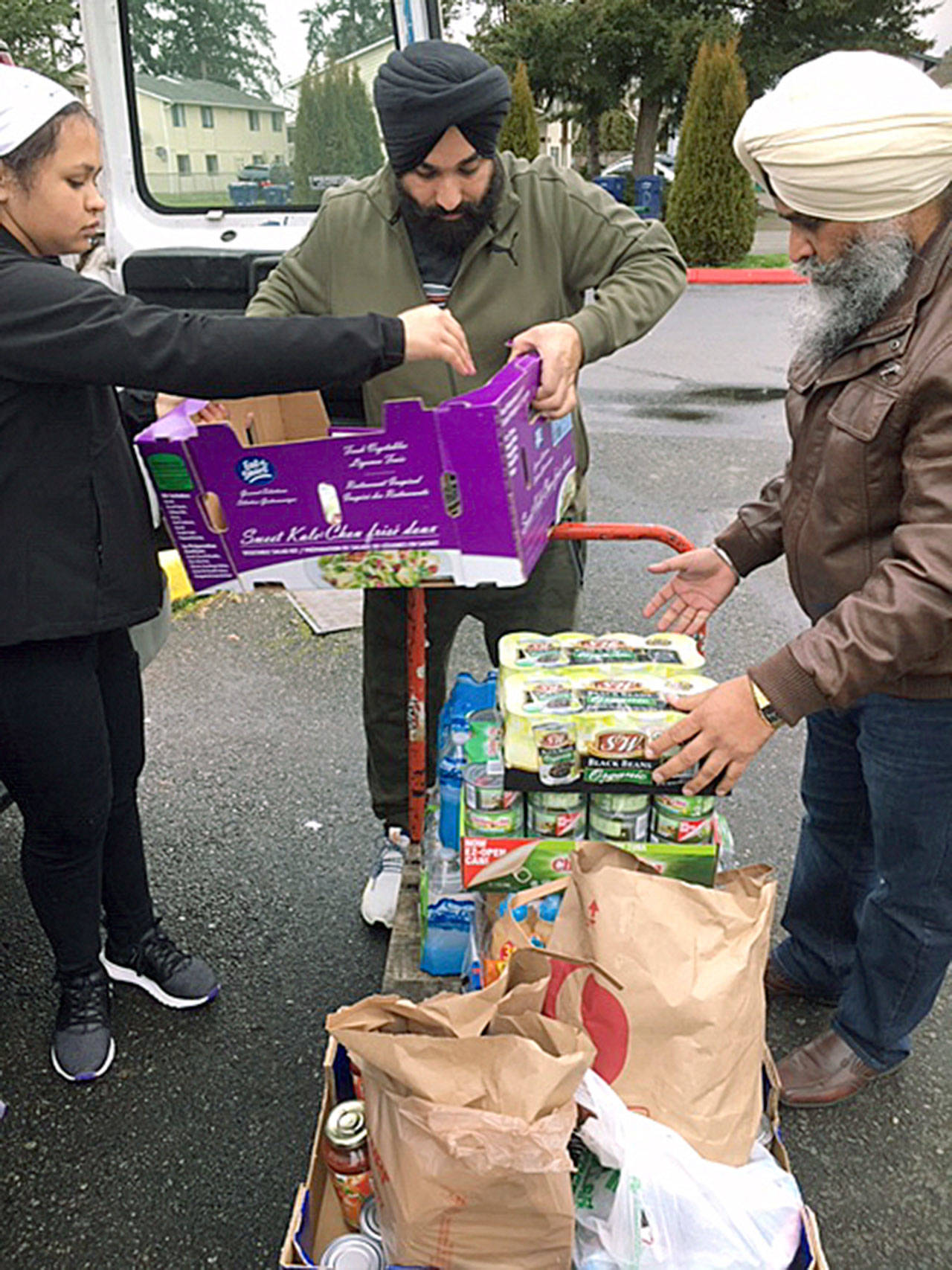 Members of the Sikh Temple in Auburn unload 700 pounds of dry goods at the Auburn Food Bank Saturday afternoon, all of it what remained of the help it had offered to federal workers and families affected by the recent, temporary government shutdown. COURTESY PHOTO