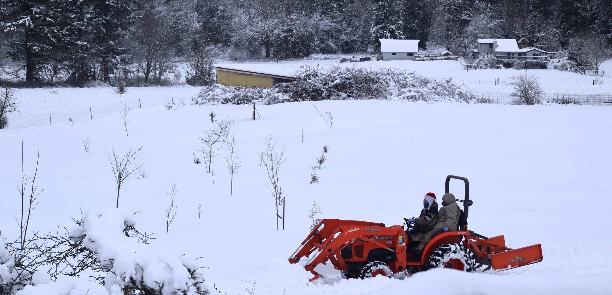 Workers use a snow tractor to clear a road in bucolic Auburn on Saturday. RACHEL CIAMPI, Auburn Reporter