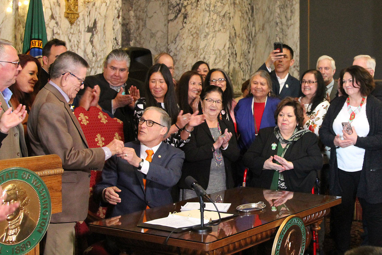 Gov. Jay Inlsee signs into law the Native American Voting Rights Act, which allows a non-traditional address to be used for voter registration for residents who live on reservations. Photo by Emma Epperly/WNPA Olympia News Bureau