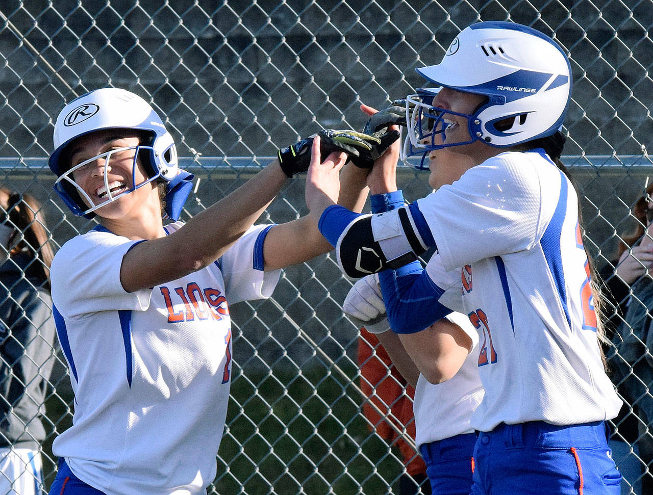 Auburn Mountainview’s Adriana Lomeli-Smith, right, celebrates her grand slam home run with Alashae Bell (1) and teammates during the Lions’ 23-22 North Puget Sound League Olympic Division softball win over Decatur on Tuesday. RACHEL CIAMPI, Auburn Reporter