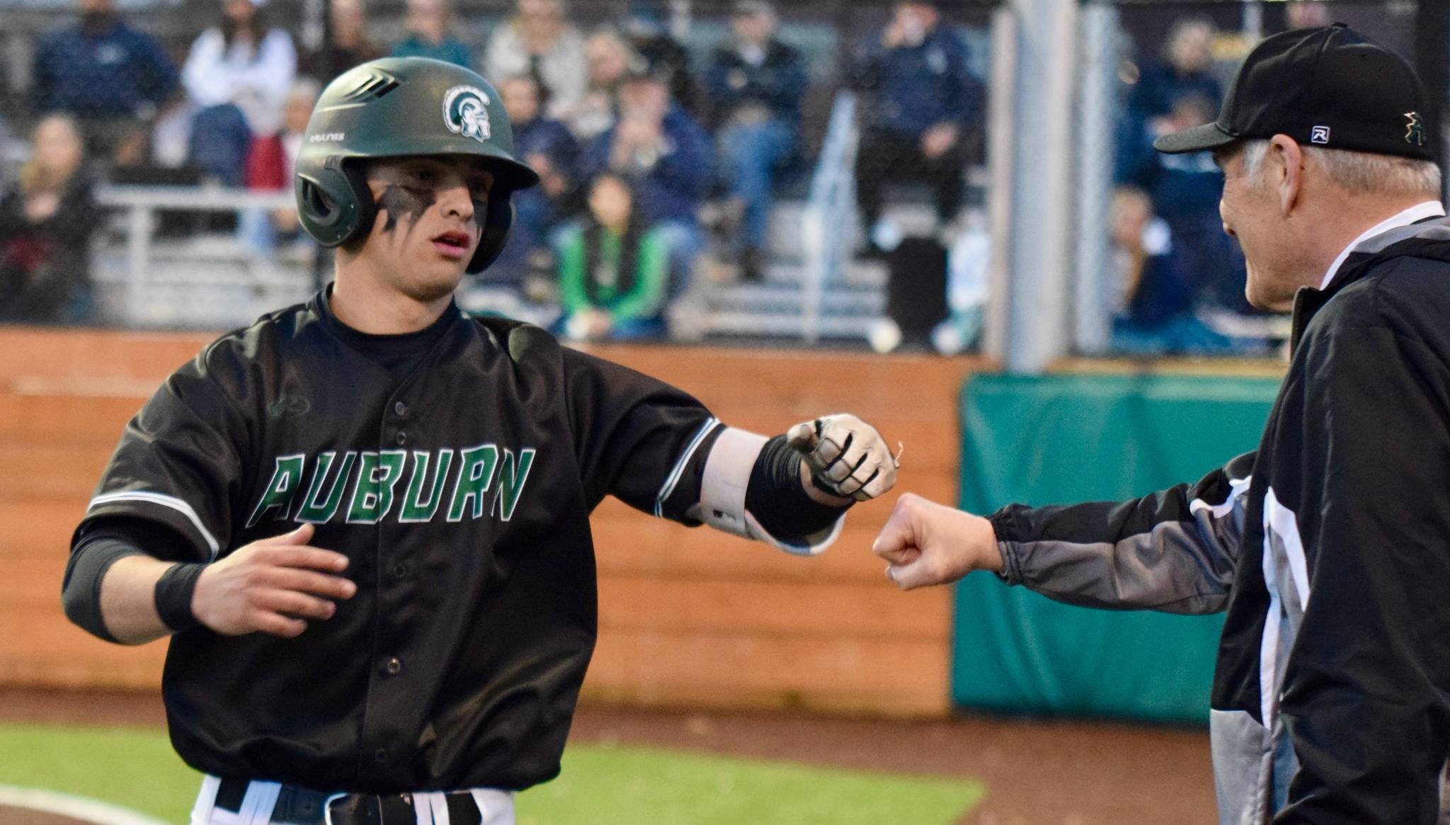 Auburn’s Cameron Antee bumps fists with coach Gordon Elliott after launching a solo home run in the second inning of Monday night’s NPSL game. RACHEL CIAMPI, Auburn Reporter