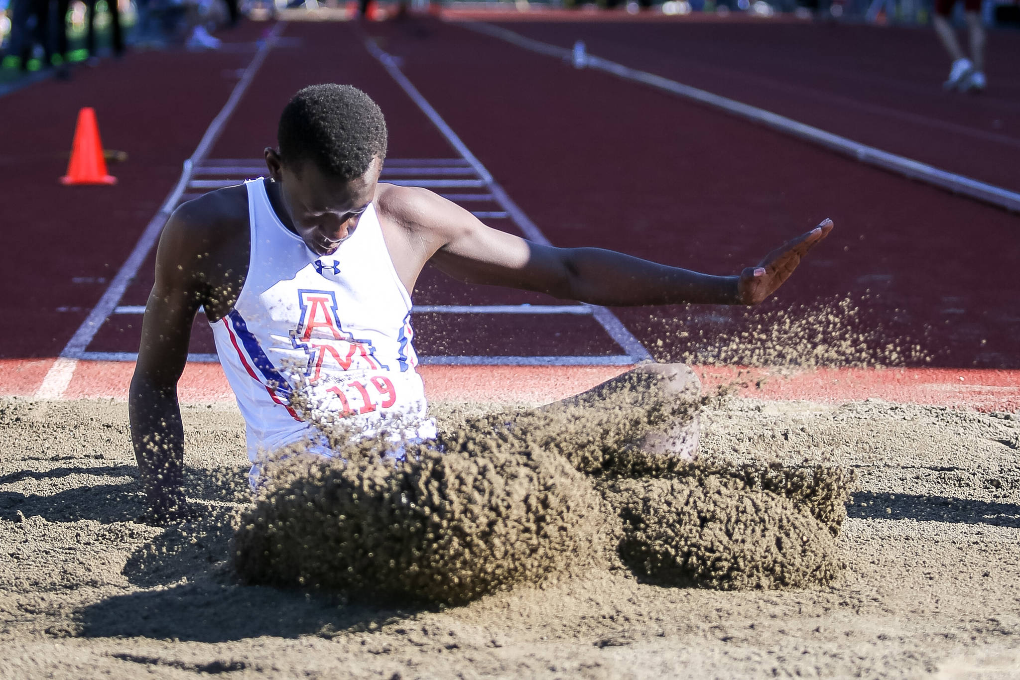 Auburn Mountainview’s Bill Benjamin scatters the sand after an attempt in the triple jump during the Kent-Meridian Track and Field Invitational at French Field last Saturday. Benjamin finished fourth with a leap of 41 feet, one-half inch. COURTESY PHOTO, Bob Sheldon