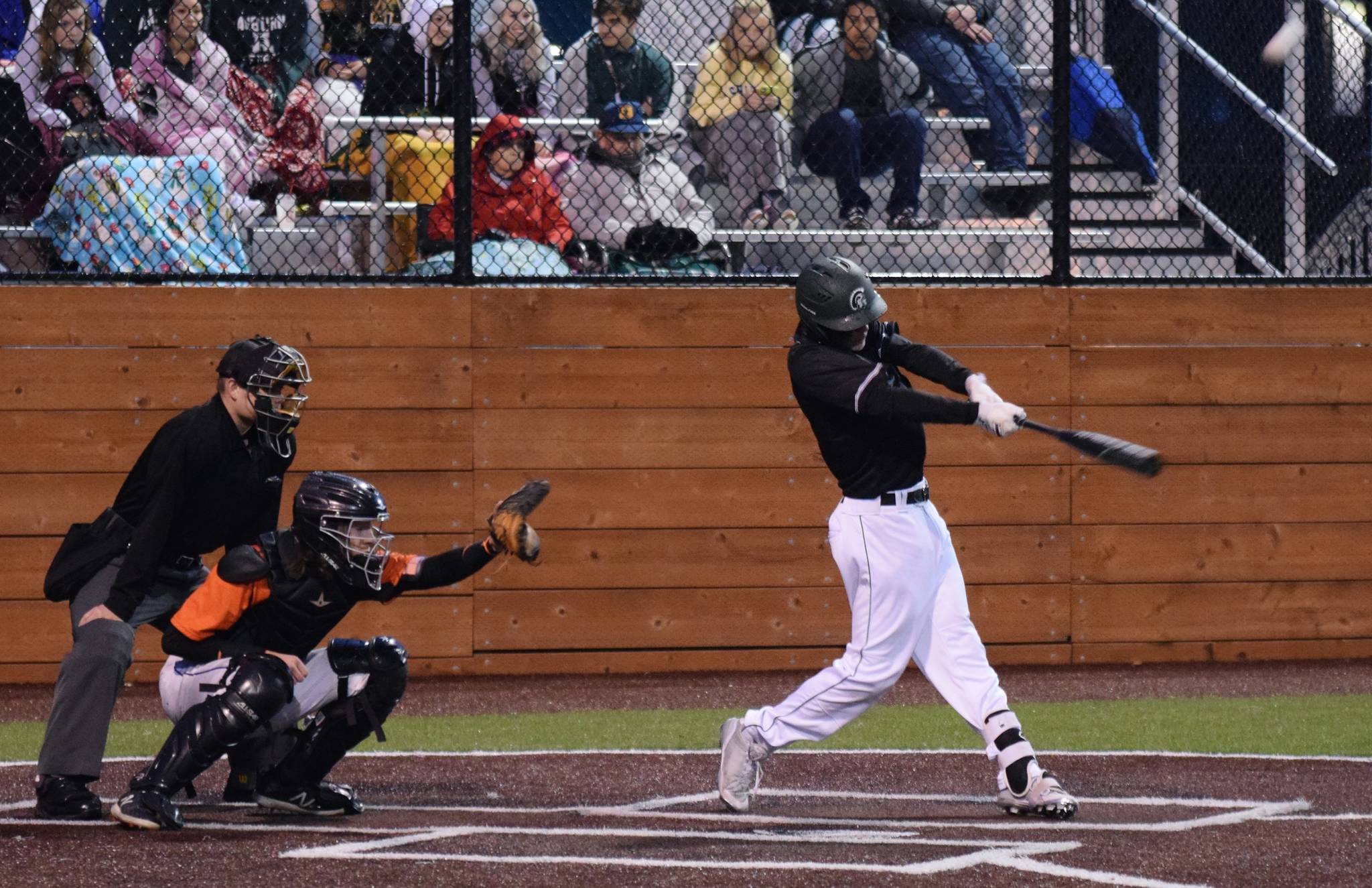 Auburn’s Evan Jilbert connects for a triple against Auburn Mountainview during NPSL Olympic play Monday night. Jilbert also doubled for the Trojans in their 9-8 win. RACHEL CIAMPI, Auburn Reporter