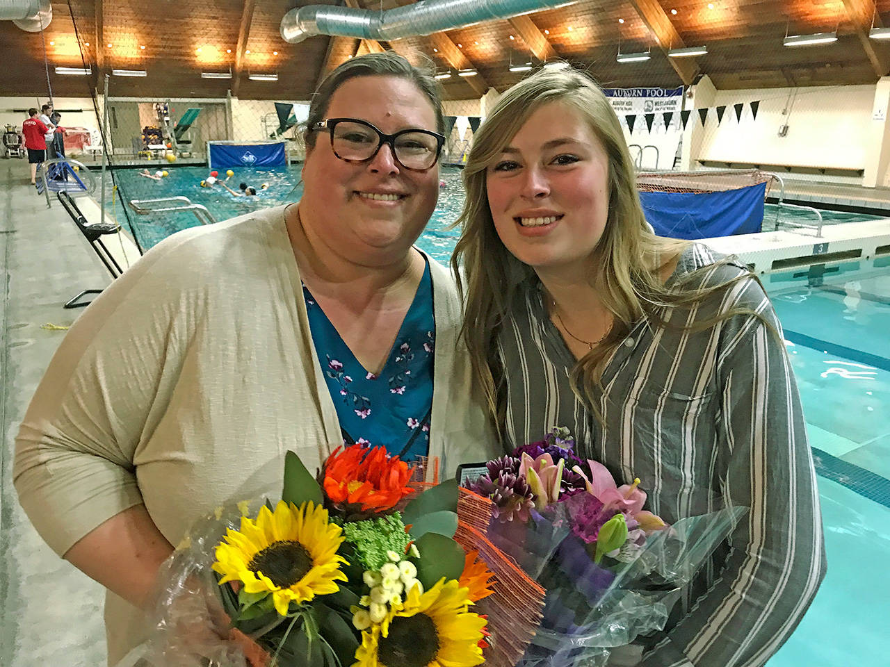 Reese Marlenee, right, and her mother, Jessica, appear at the Auburn District Pool, where Reese collapsed from a heart attack at an Auburn Mountainview water polo team practice March 5. Thanks to first-responders, the 16-year-old girl is doing well today. Mother and daughter returned to the pool on Wednesday to honor and thank those responsible for saving the girl’s life. MARK KLAAS, Auburn Reporter