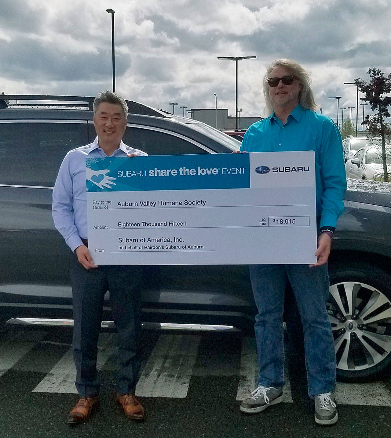 Jay Lee, general manager of Rairdon’s Subaru of Auburn, left, presents a check of more than $18,000 to Phil Morgan, president and CEO of the Auburn Valley Humane Society. COURTESY PHOTO