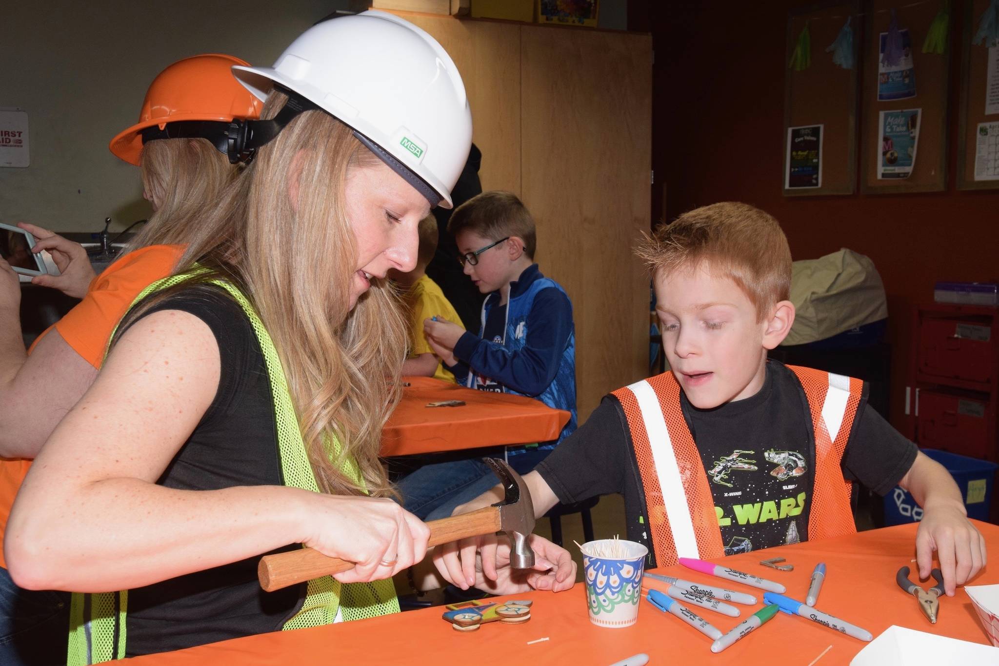 Luke Lebhart, 7, makes an art tractor with his mom, Summer, during the Ladies and Lil’ Gents event Saturday. RACHEL CIAMPI, Auburn Reporter