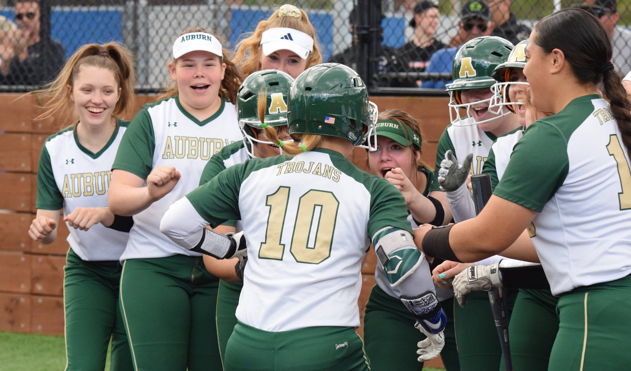 Teammates greet Kiana Adams (10) after the Auburn junior hit a grand slam during the Trojans’ 6-1 win against Auburn Riverside on Monday. RACHEL CIAMPI, Auburn Reporter