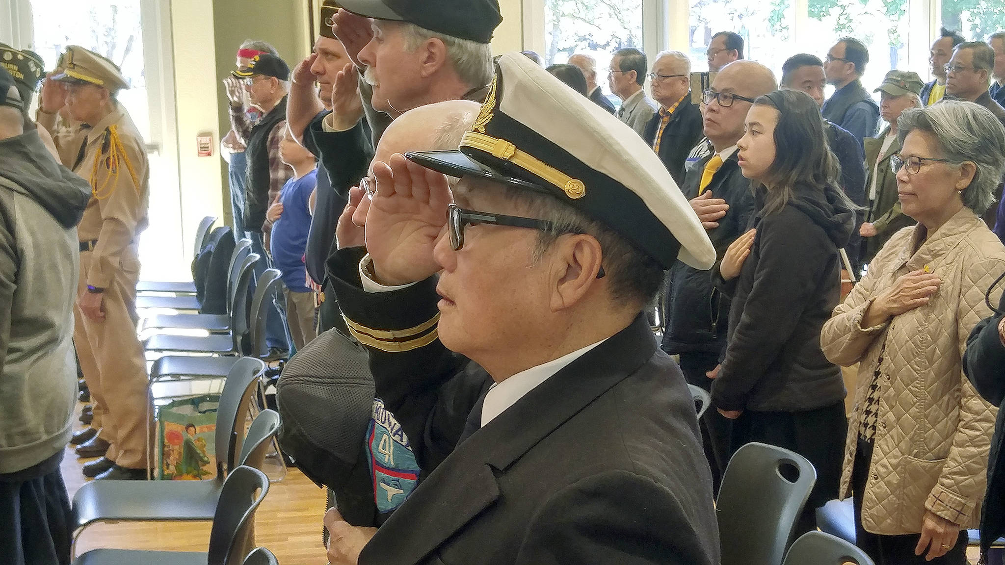 Thao Van Nguyen, a former officer with the South Vietnamese Navy, salutes the flag of his country during Black April ceremonies at Auburn’s Activities Center at Les Gove Park last Sunday, marking the 44th anniversary of the fall of Saigon on April 30, 1975. ROBERT WHALE, Auburn Reporter