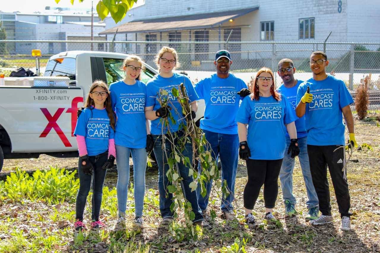 Volunteers helped clear debris and blackberry bushes along the fence line at the Auburn Valley YMCA during Comcast Cares Day. COURTESY PHOTO, Comcast