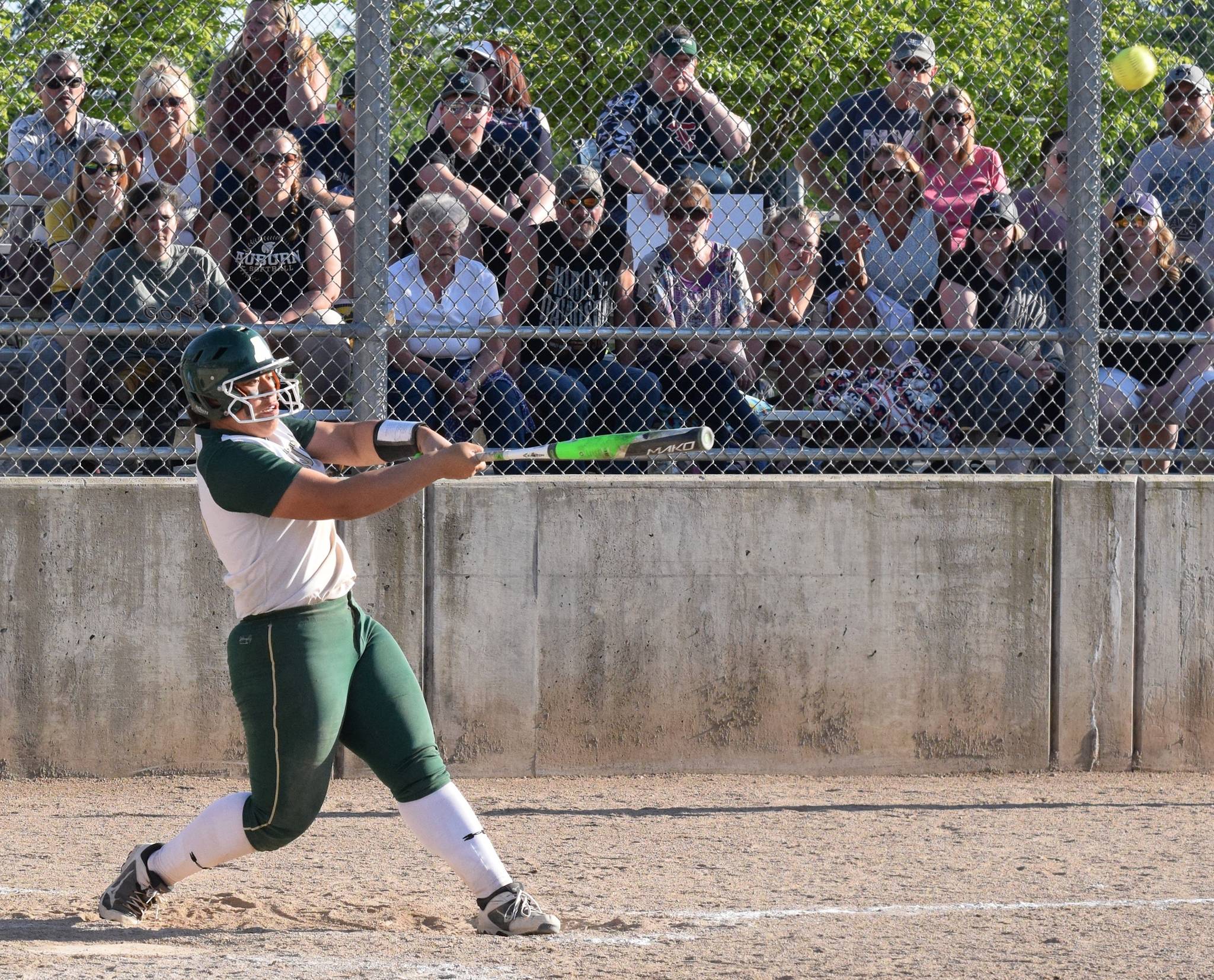 Auburn’s Lynetti Aumua drills a fifth-inning grand slam home run in the Trojans’ 13-2 NPSL tournament win against Kennedy Catholic at the Kent Service Club Ballfields on Friday. RACHEL CIAMPI, Auburn Reporter