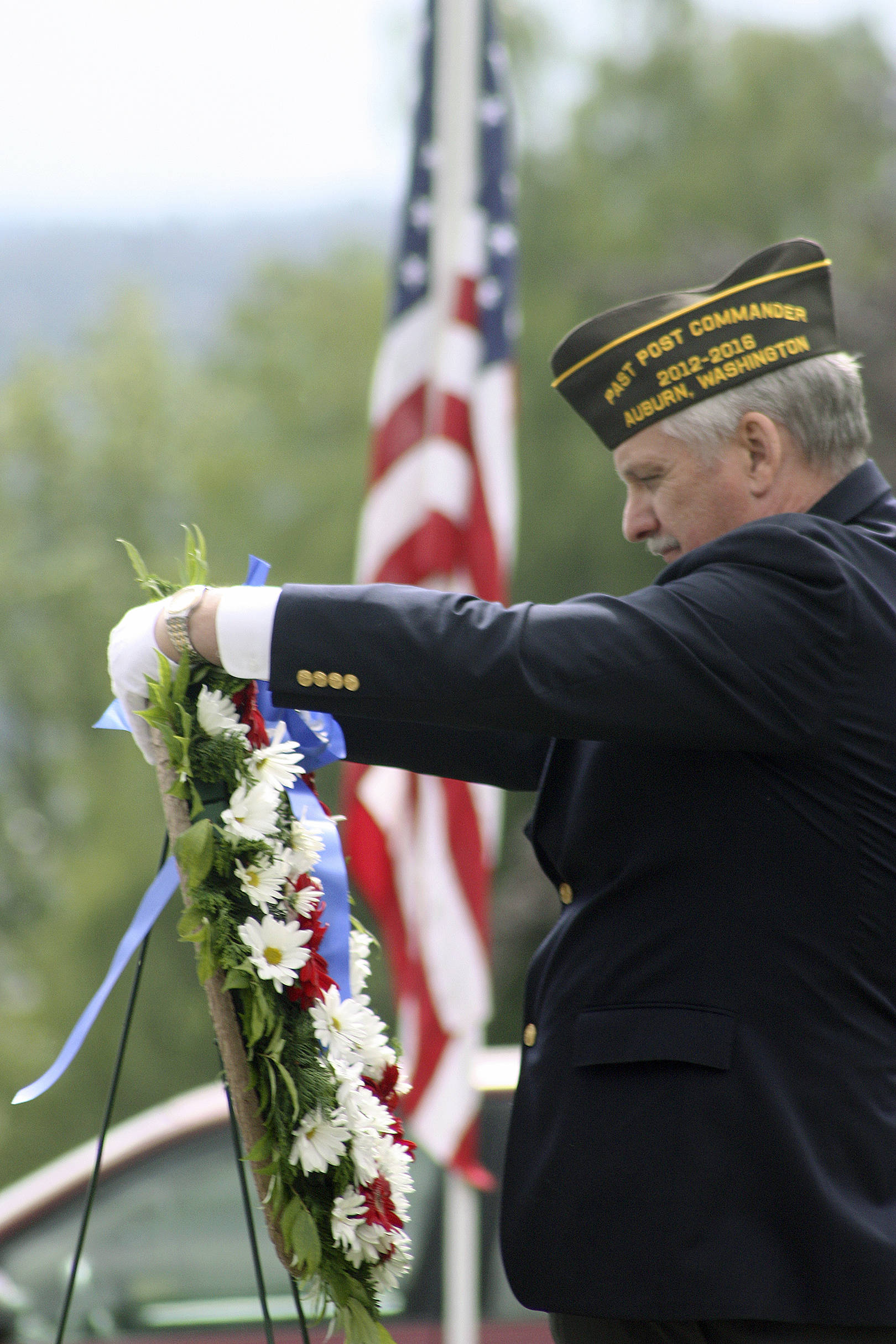 Frank Bannister, former VFW Post 1741 commander, lays a memorial wreath during last year’s Memorial Day observance at Mountain View Cemetery. MARK KLAAS, Auburn Reporter