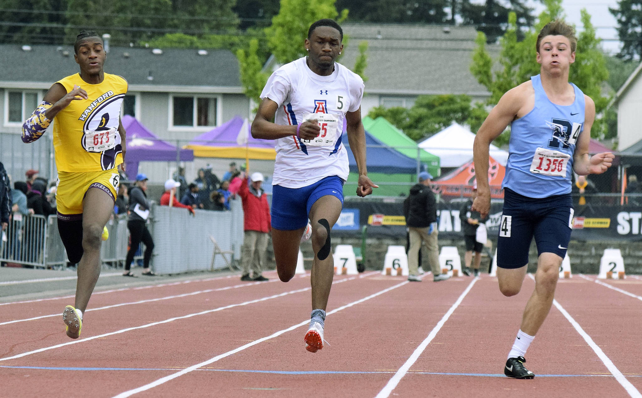 Auburn Mountainview’s Chris Penn, middle, scoots to a second-place finish in the 100-meter 4A state final at Mount Tahoma High School in Tacoma last Saturday. Penn would later capture the 200 title. RACHEL CIAMPI, Auburn Reporter